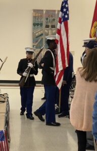 Military personnel presenting the flag.